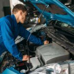 mechanic-repairs-car-engine-motor-diagnostic-small.jpg